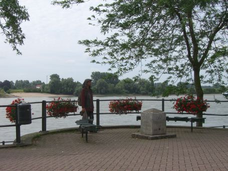 Rees : Rheinpromenade, Bildmitte lebensgroße Holzfigur, von Peter Nettesheim, Köln